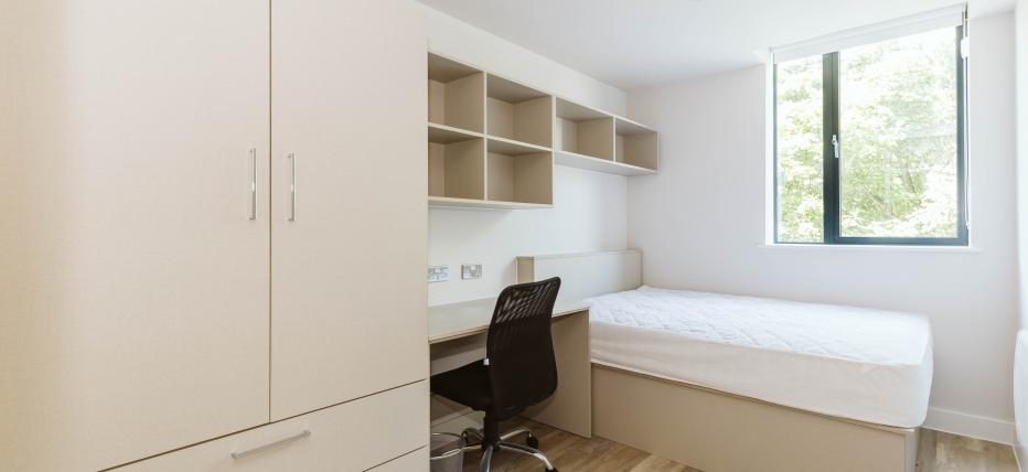 Bed, desk with chair and wardrobe