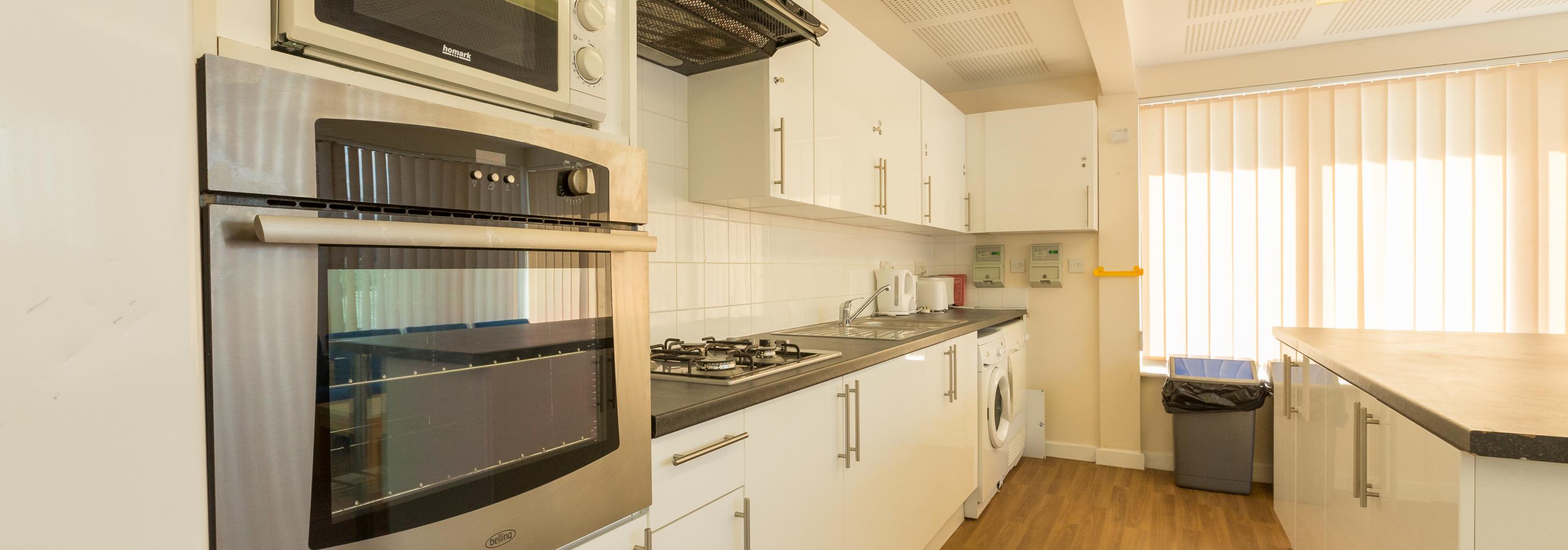 Top floor kitchen, oven, microwave, gas cooker, extractor fan, washing machine, bin, kettle, toaster, windows and blinds