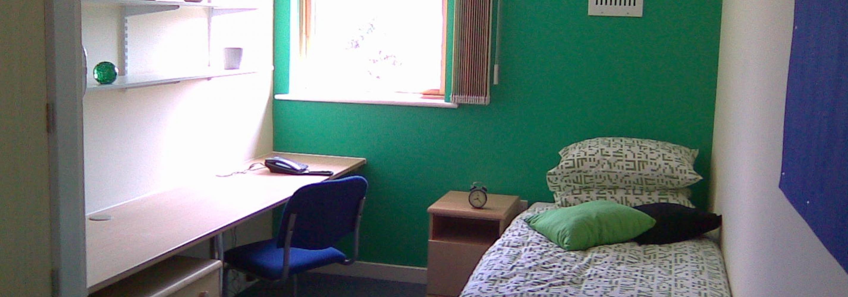 Bedroom, bed, window, desk, chair, shelves and noticeboard