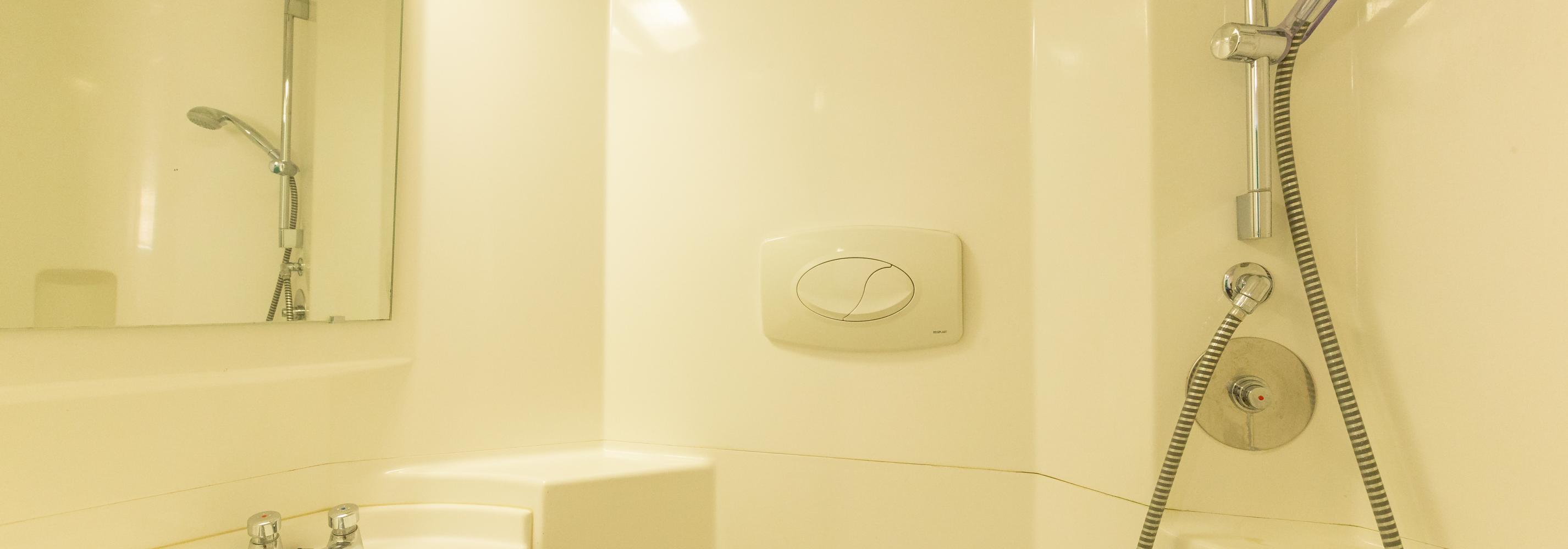 En-suite, shower, sink and mirror