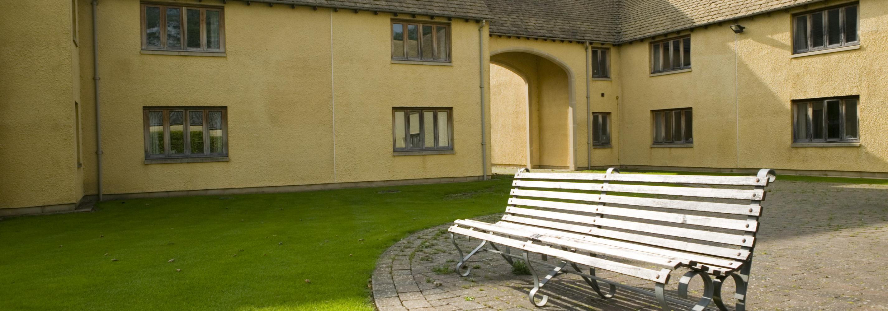 Exterior of building with a courtyard and a bench