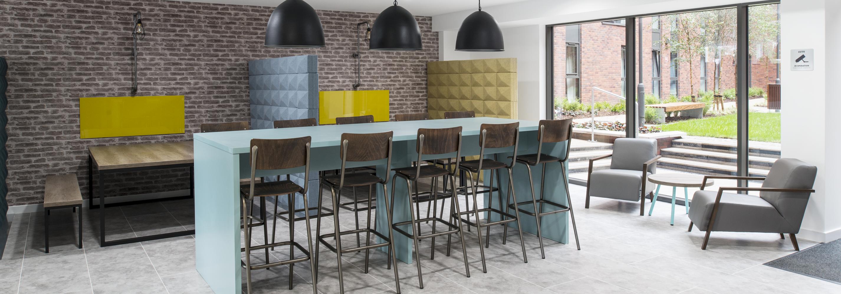 Common Room - Bar with stools and a range of tables and chairs/benches