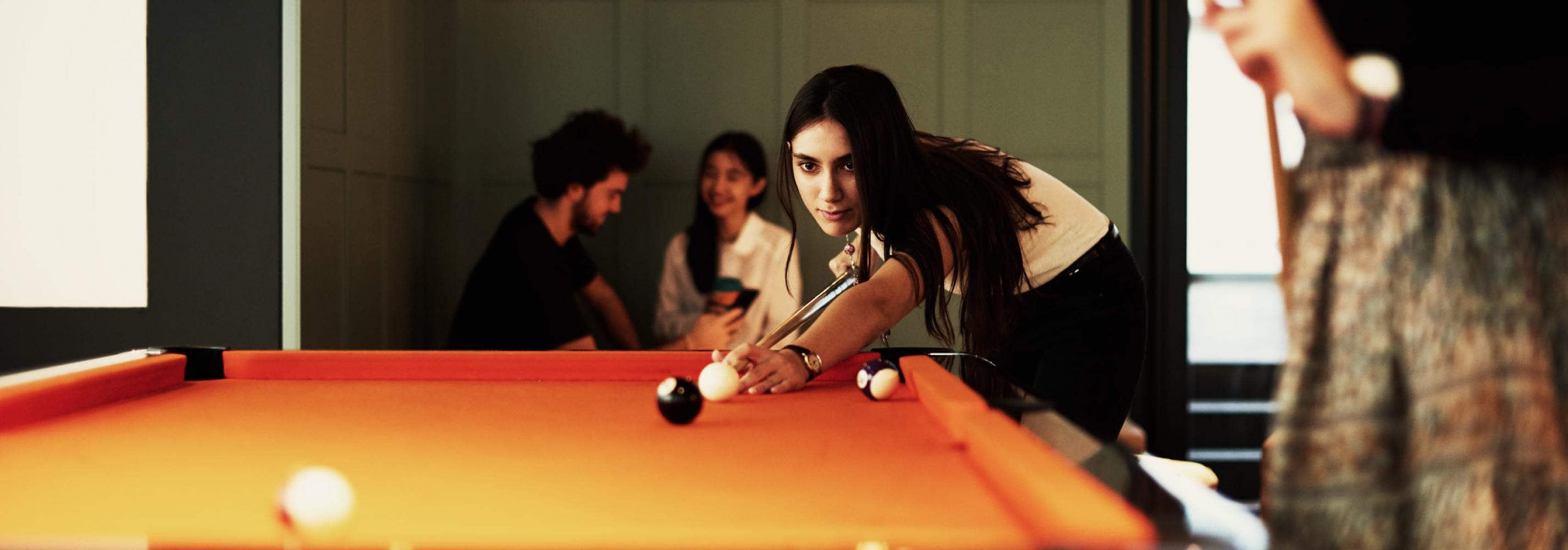 Students playing on a Pool table