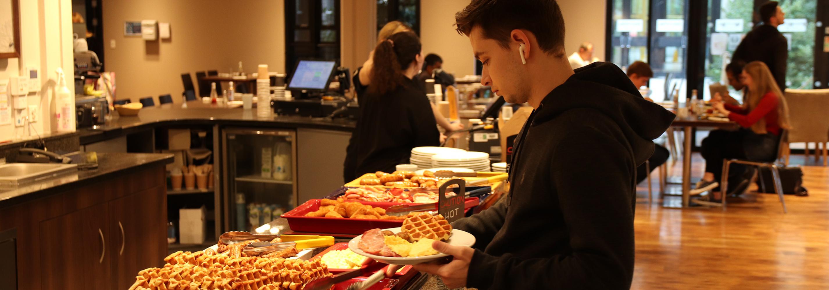 Student eating breakfast in Dolche Vita as part of included Bed and Bistro meal plan