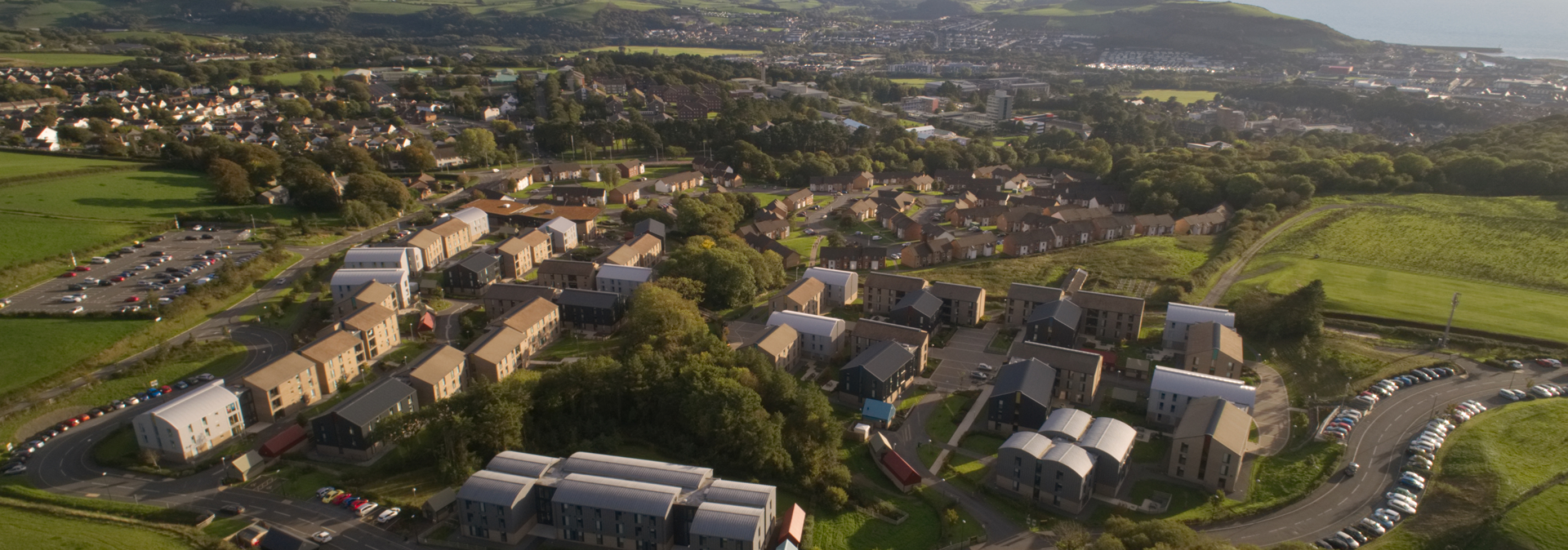 Aerial image of Fferm Penglais looking down on Pentre Jane Morgan, Penglais Campus and Aberystwyth seafront. 