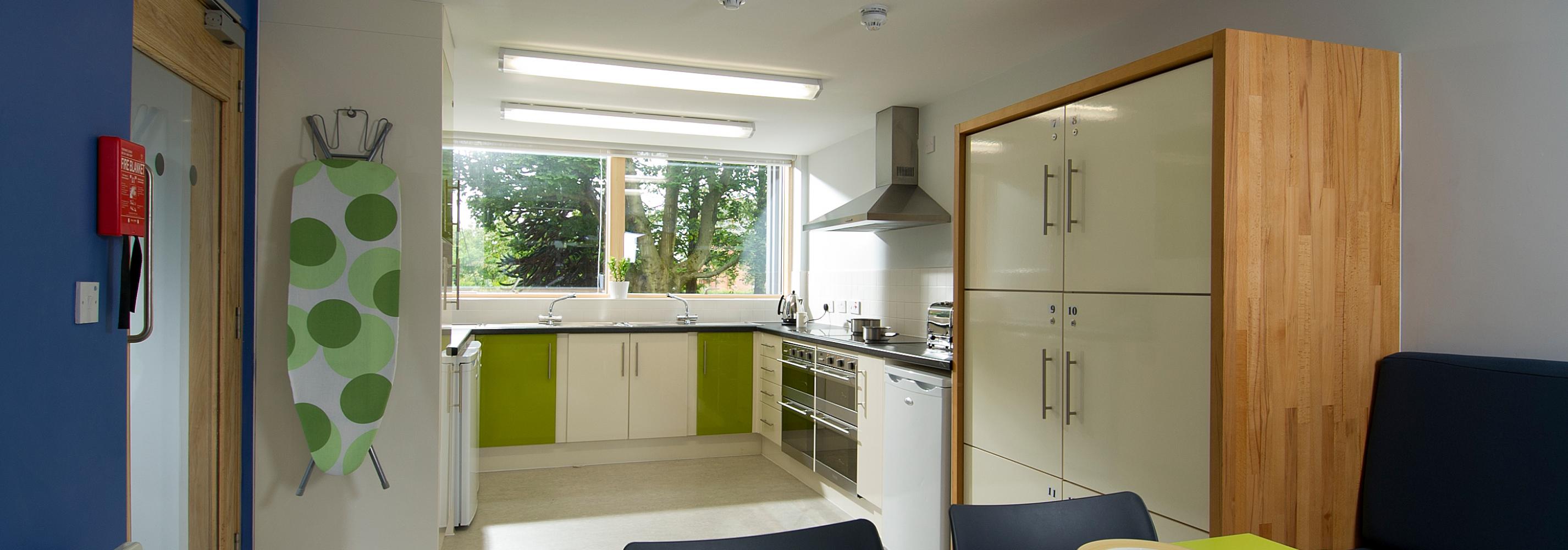 Interior of kitchen and dining area showing facilities and individual food locker storage.