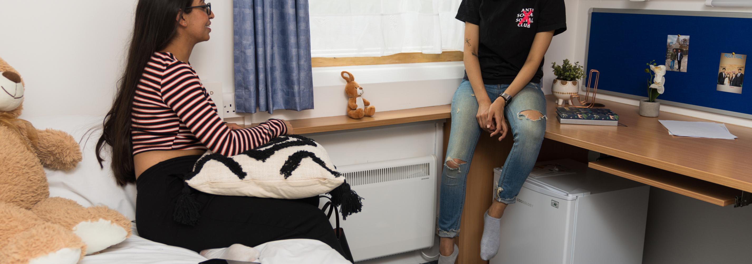 Students chatting in a single ensuite room on the de Havilland campus