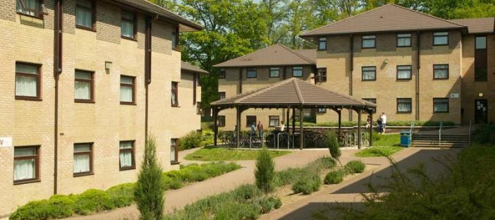 Two medium sized three floor accommodation blocks with a walk way to a central matching permanent gazebo.